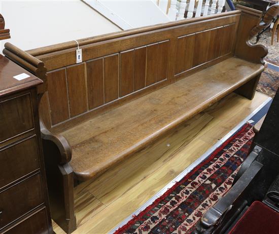 A church pew W.230cm